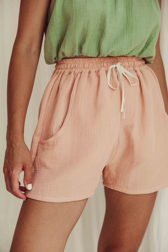 Shop women's summer shorts online in Hong Kong and Singapore. Organic cotton women's shorts in peach colour have 2 pockets and an elastic waist, made by Liilu. MiliMilu offers a wide range of sustainable women's fashion online, women's organic cotton summer clothes and linen dresses with many Mini me styles.