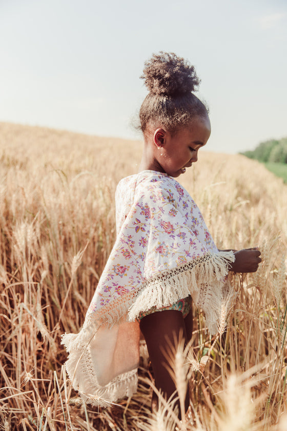 The Mael beach cape in Cream Bucolia Fields print is made with organic cotton, which is very soft and absorbent. This girl's beach cover-up is made with organic cotton and is soft inside by Louise Misha. The best gift for baby shower, present for babies and also present for kids. Shop the widest summer clothing online.