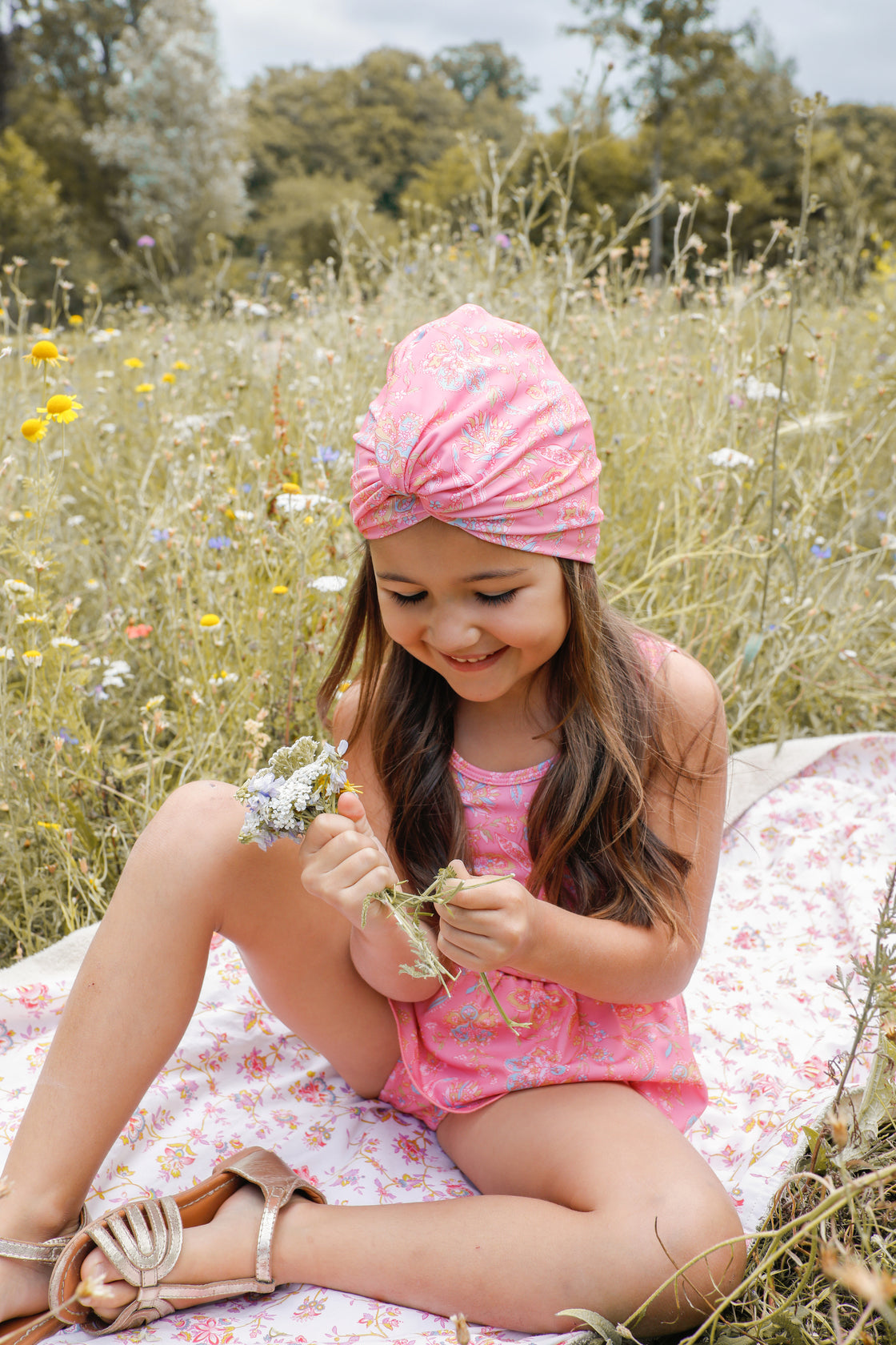 The very popular and adorable recycled girl's turban is back in a new print - pink mallow romance. It is made from an SPF 50 protective fabric and designed in a turban-style swim cap. Louise Misha, This versatile kids accessory functions as both a girl's swim hat and a summer hat, providing excellent sun protection.