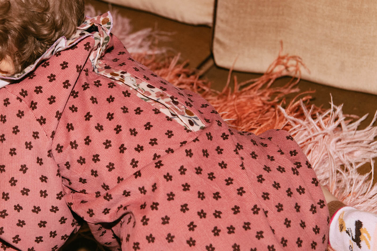Pink velvet baby romper with a beautiful flower print - the best sustainable baby clothing. The baby girl romper with flowers is made of lightweight velvet.