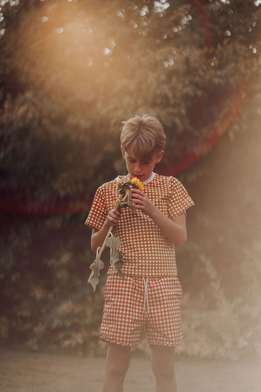 Boy wearing Sienna Gingham swim trunks, full body view showing fit and style of eco friendly boys swimwear