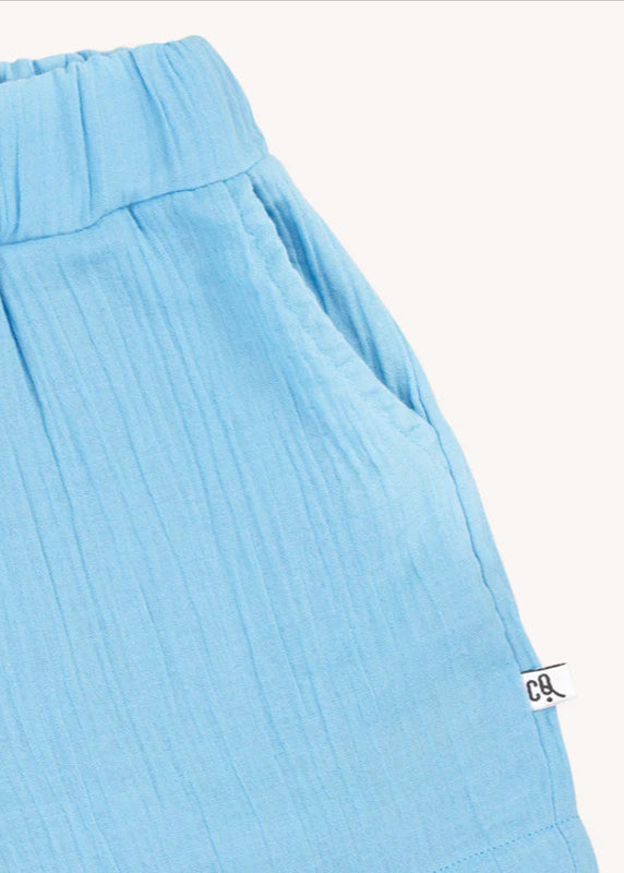 Shop organic muslin shorts with a light blue & pockets online at MiliMilu. They are made with organic cotton muslin, breathable and extra light for summer.