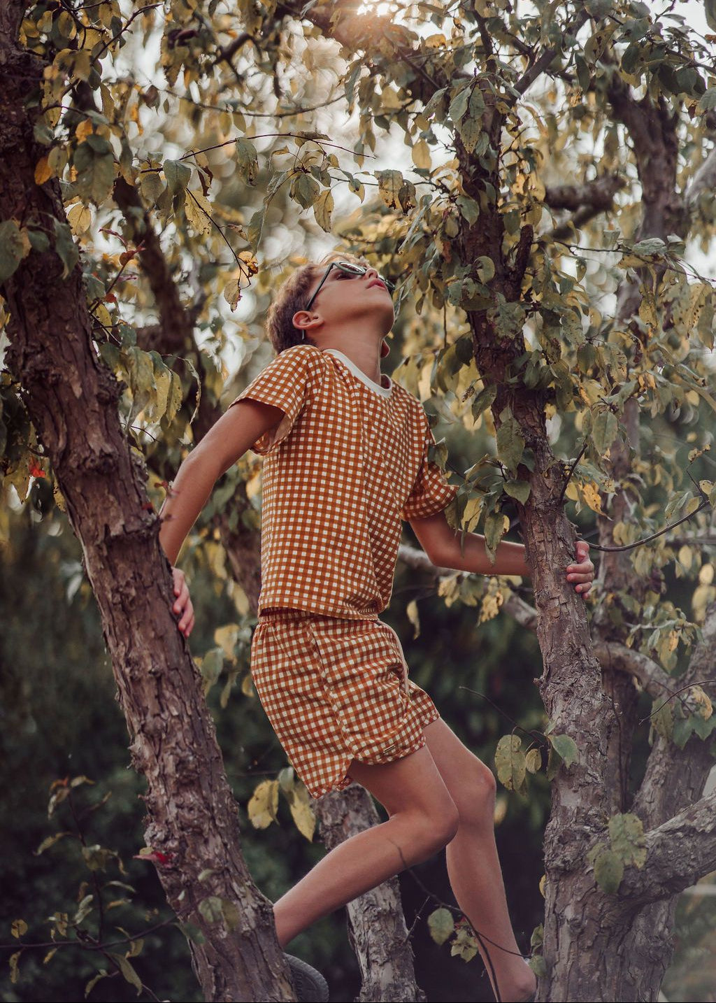 Boy wearing Sienna Gingham swim trunks, beach Hong Kong Singapore Australia, summer