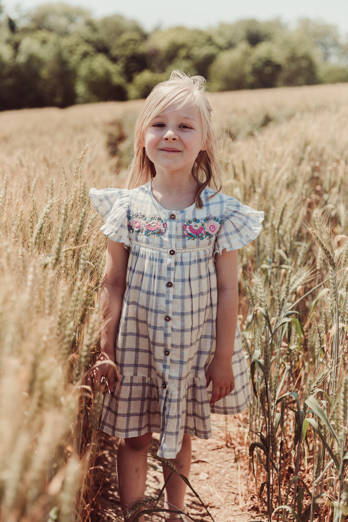 The most stunning girl summer dress - Caroline, with its blue river checks pattern, adorable ruffled design enhances the simplicity and style of this fabulous girl dress. The girl's summer dress, made from high-quality lightweight organic cotton by Louise Misha. Shop girls summer clothing and summer dresses online.
