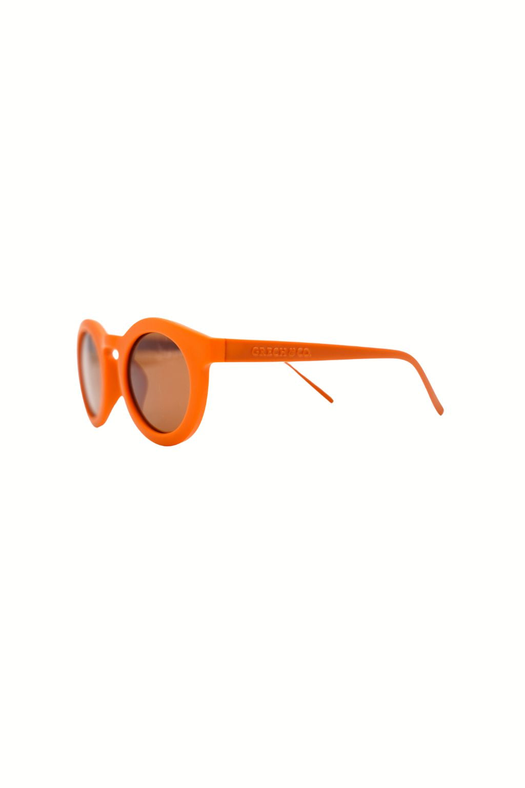Sustainable sunglasses in orange by Grech & Co are eco-friendly/non-toxic break-resistant material with polarised lenses and UV400 protection. Best kids gift.