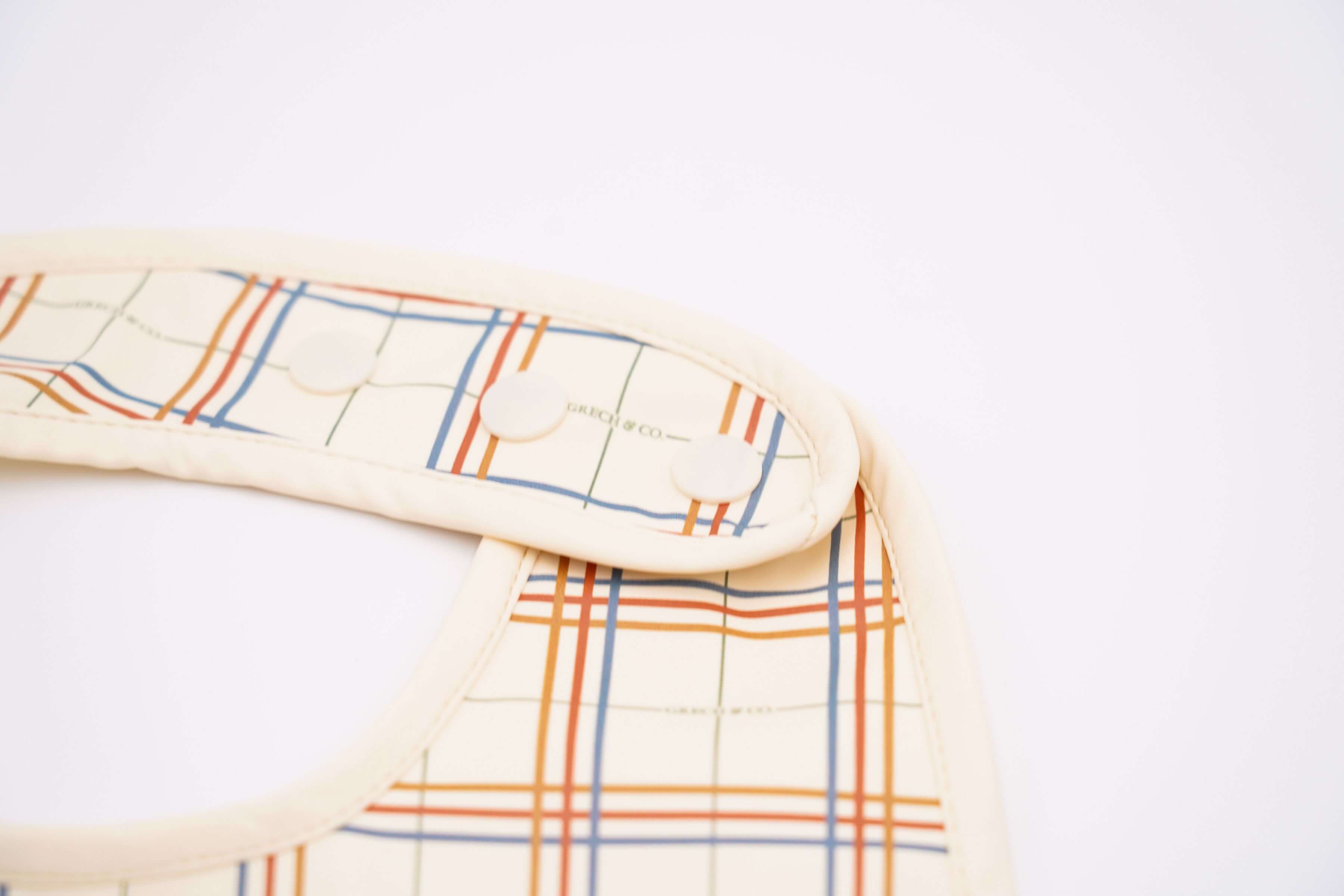 Baby bib online in Hong Kong and Singapore from eco-friendly and sustainable materials. Keep mealtimes cleaner and fun for all with the Grech & Co. easy-to-clean and store plaid baby bib, water-resistant recycled Oeko tex material. Stylish and practical baby and kids' bib for everyday use and best bib for travelling.
