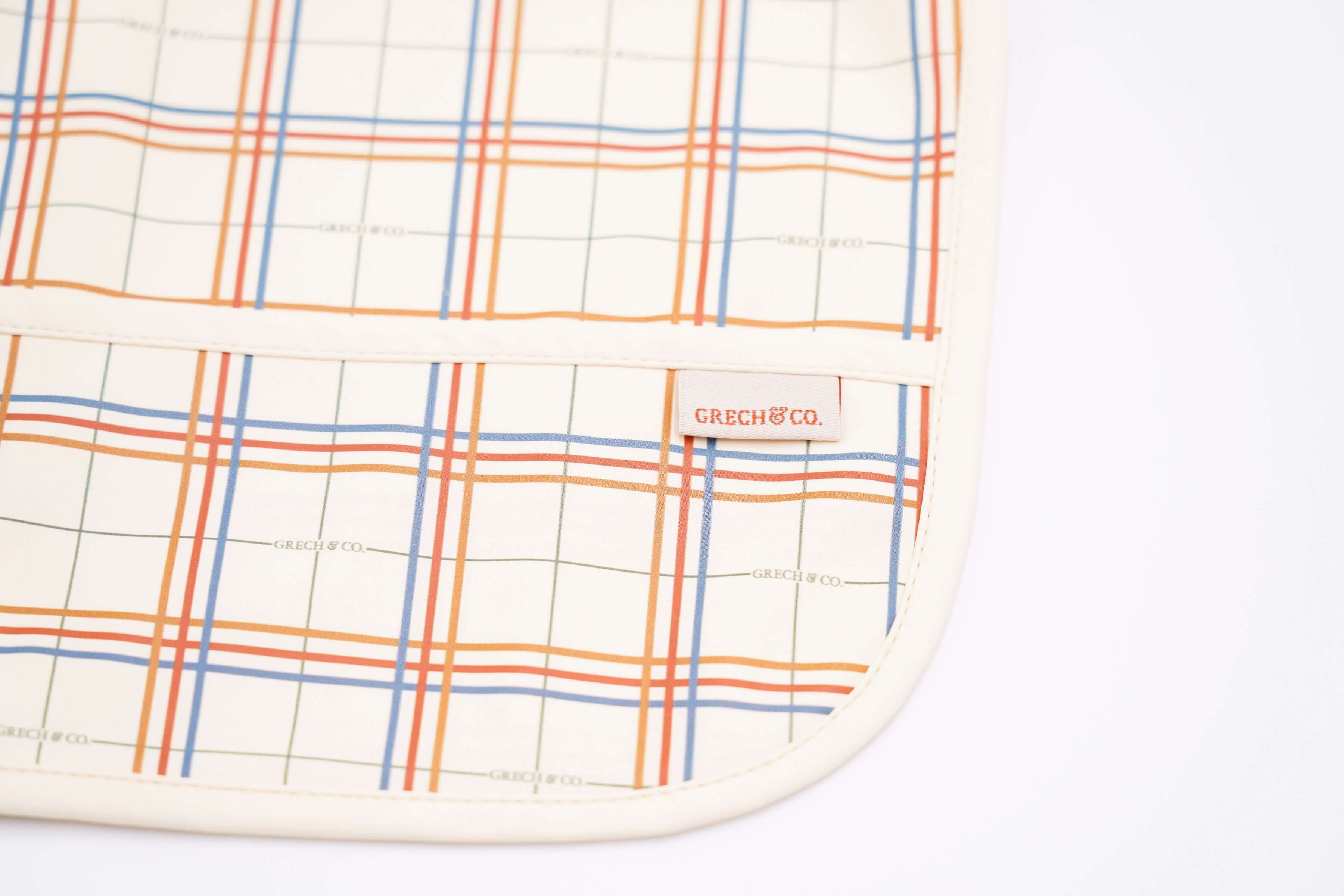 Baby bib online in Hong Kong and Singapore from eco-friendly and sustainable materials. Keep mealtimes cleaner and fun for all with the Grech & Co. easy-to-clean and store plaid baby bib, water-resistant recycled Oeko tex material. Stylish and practical baby and kids' bib for everyday use and best bib for travelling.