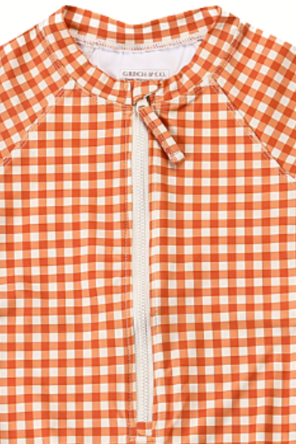 The long sleeve swimsuit for girls with rashguard and ruffle in Sienna Gingham by Grech and Co. Shop the best sustainable girl swimsuit online at MiliMilu.