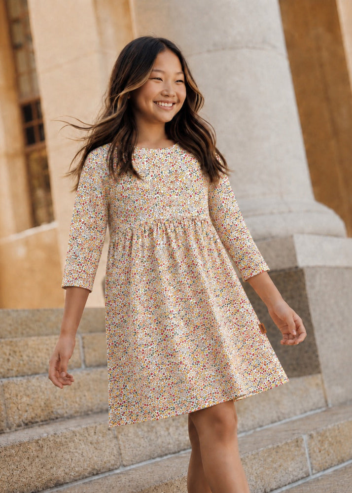 Girl wearing floral print dress with small flowers all-over – organic cotton girls dress by Milimilu
