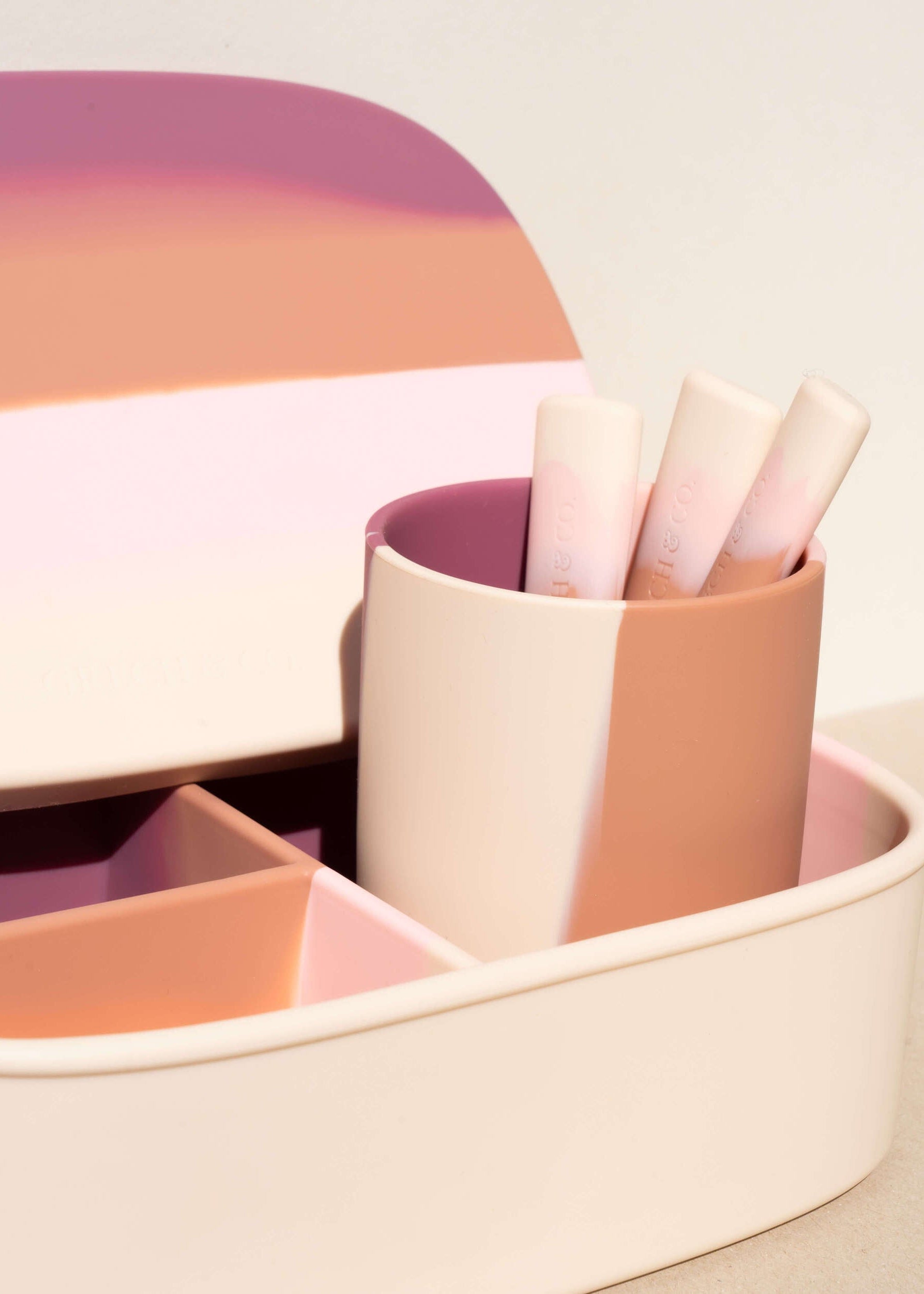 Grech & Co pink silicone toddler mealtime set with cup, divided plate and cutlery in blush, berry and terracotta tones on warm beige background — sustainable kids tableware at Milimilu