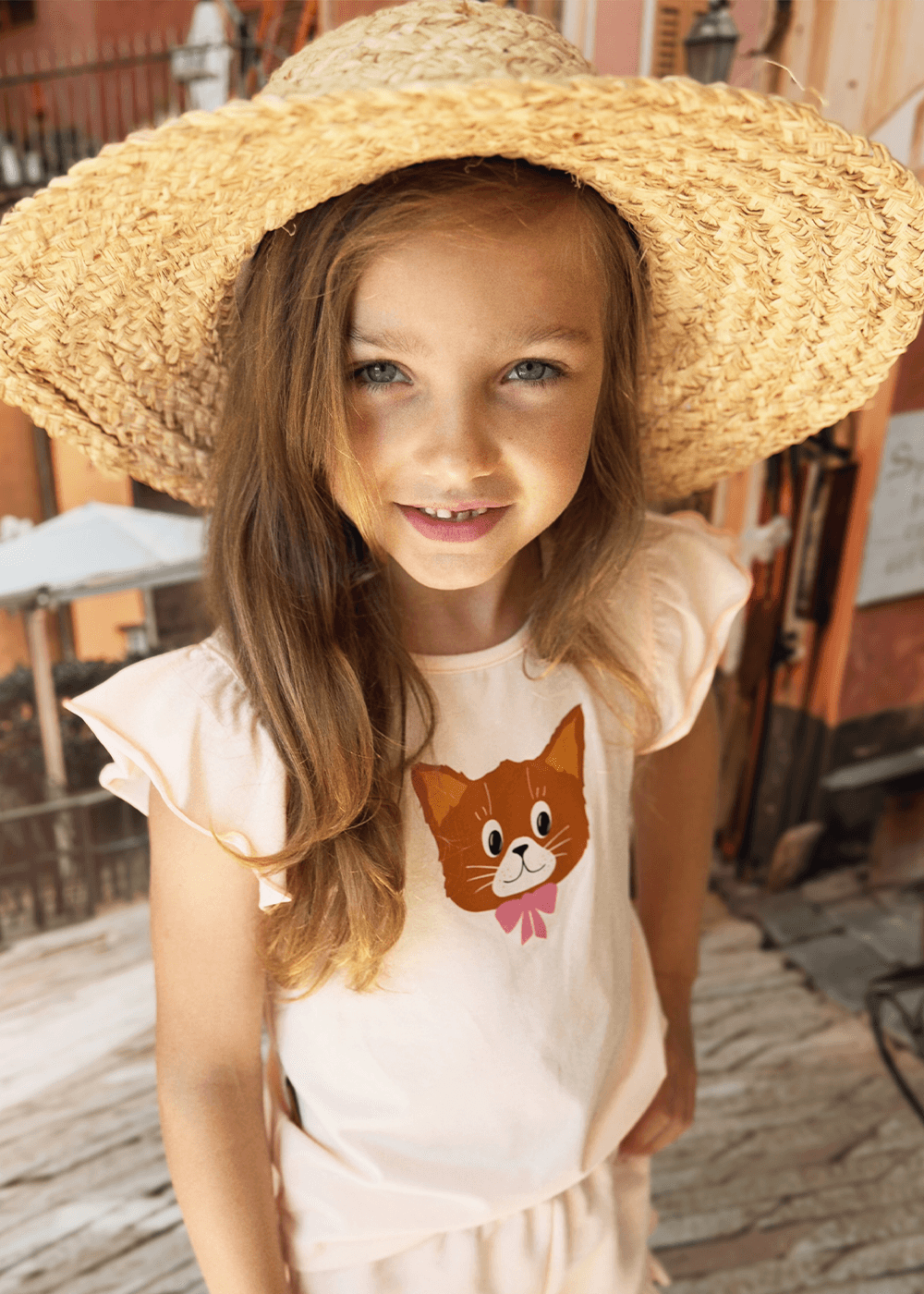 Girl wearing pink cat print ruffle top with flutter sleeves – organic cotton girls top by Milimilu