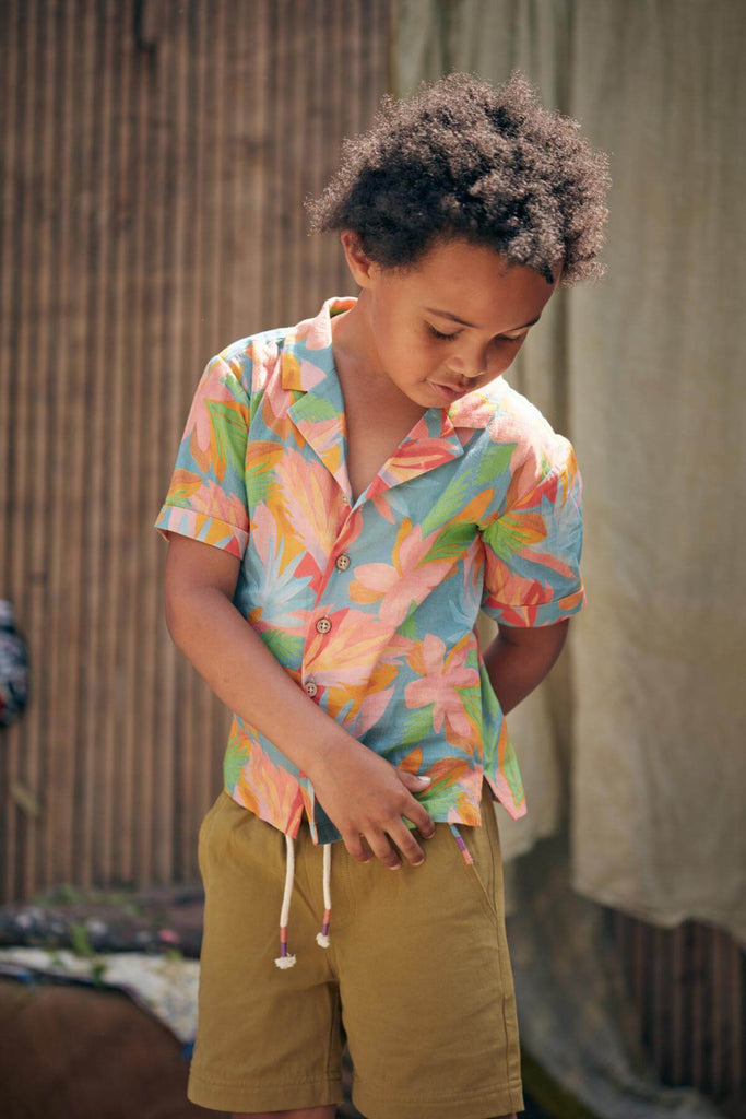 Check out Louise Misha's Jungle print organic cotton shirt for boys! It's lightweight, breathable, and has a wooden button closure and front pocket, the best boys summer shirt. Shop for it online in Hong Kong and Singapore, along with other sustainable kids' clothing options from baby to teen clothing.