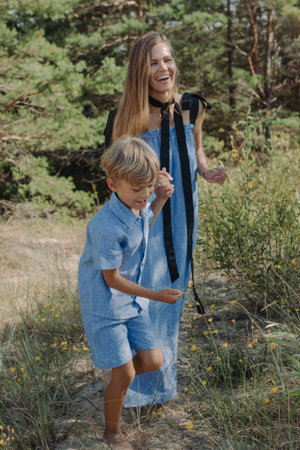 Mommy and me matching blue linen fashion, coordinated family outfits for summer occasions.