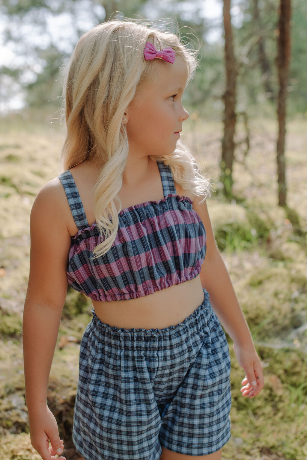 Mommy and daughter matching crop tops, coordinated family fashion sets.