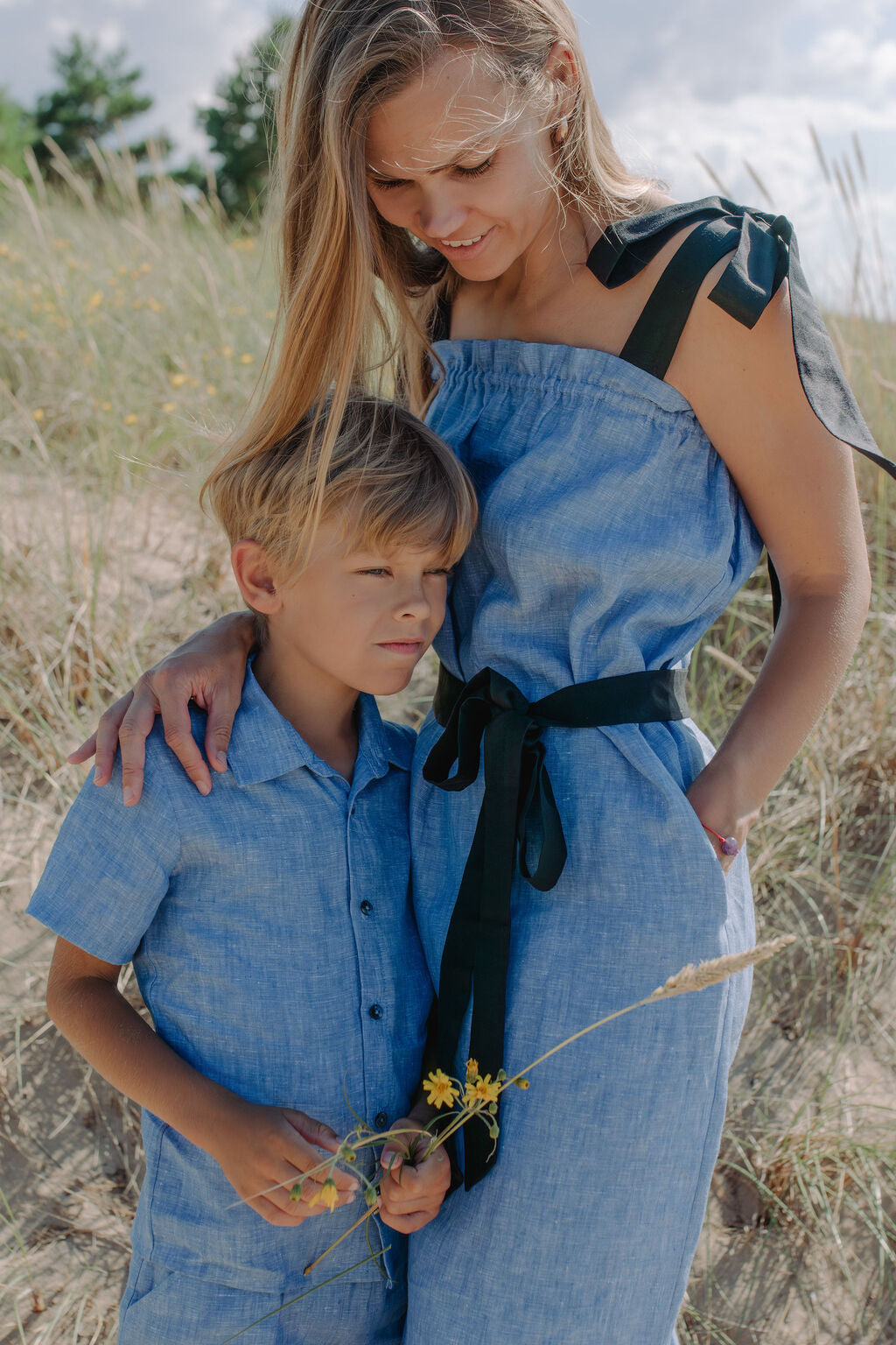 Mommy and son matching blue linen fashion, coordinated family outfits for special occasions.