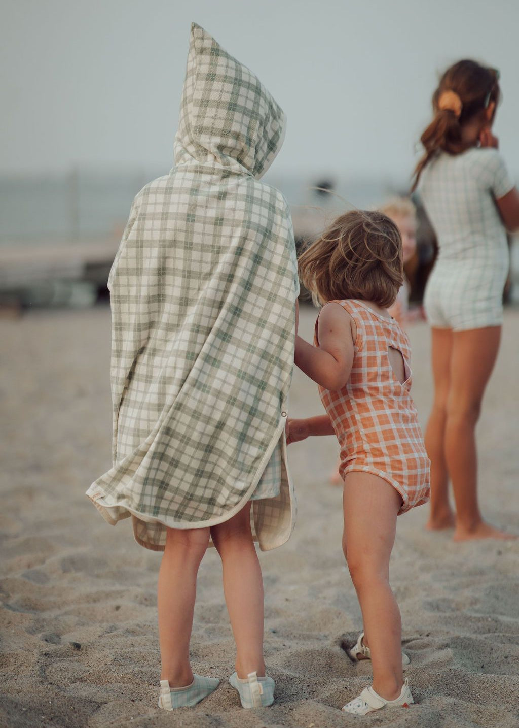 Side view of fern plaid towel poncho showing button closure details