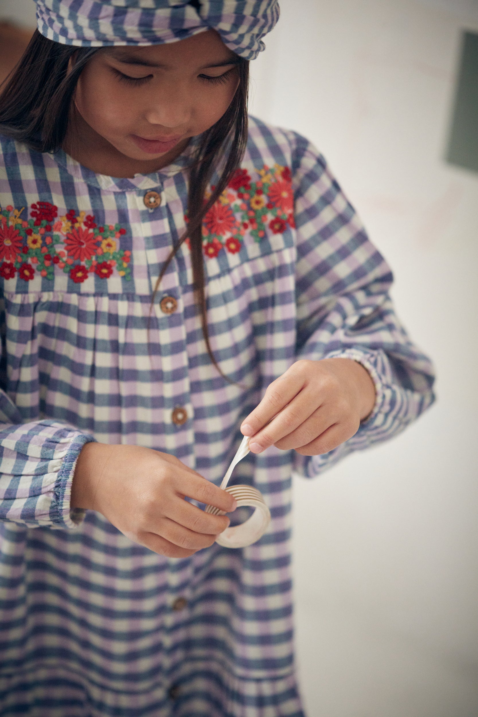 Massilian organic cotton dress is a stunning piece in a soft purple and blue check pattern. Shop the best sustainable kids clothing by Louise Misha at MiliMilu.
