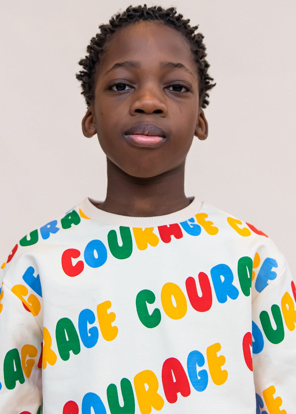 Kids organic cotton sweater with colourful Courage print; front view