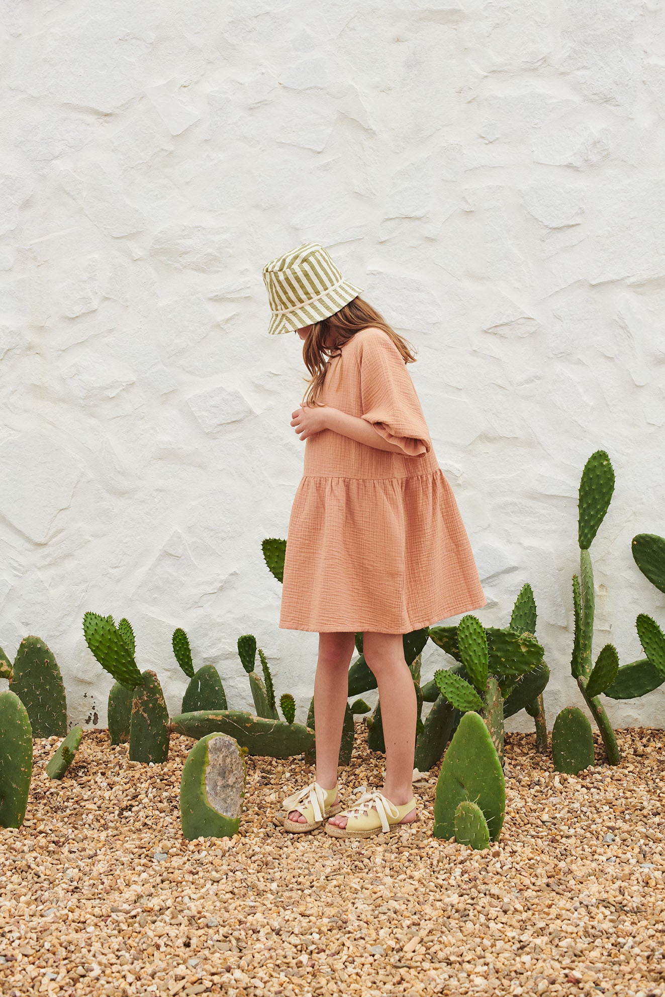 The breathable organic cotton girl's muslin dress in toast colour. MiliMilu Lifestyle offers organic cotton kids clothing and organic cotton girl dresses.