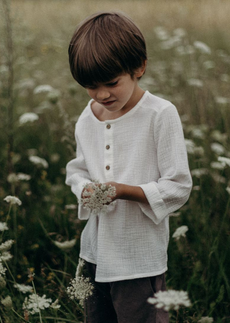 Handmade kids muslin shirt in white is made from organic cotton and is breathable and lightweight, the best clothing for hot and humid weather.