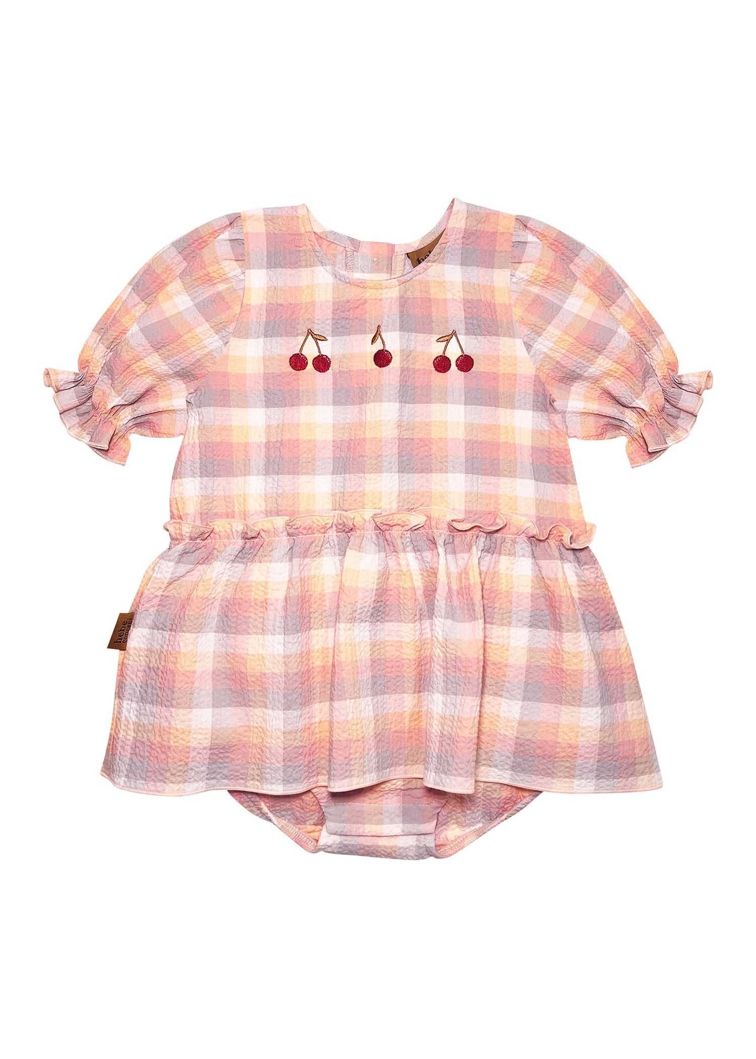 Close-up of light peach check baby girl romper with delicate cherry embroidery detail and button closure