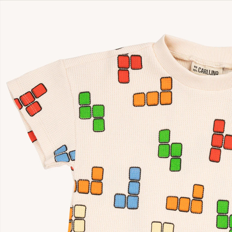 Shop the Blox Crewneck White T-Shirt is a must-have for every kid's wardrobe. With its classic Tetris-style print  t-shirt it's perfect for game-loving kids. Tailored for boys and teenagers, the collection offers a vibrant array of colors to ensure they stand out - unique kids clothing. Organic cotton t-shirt for kids.