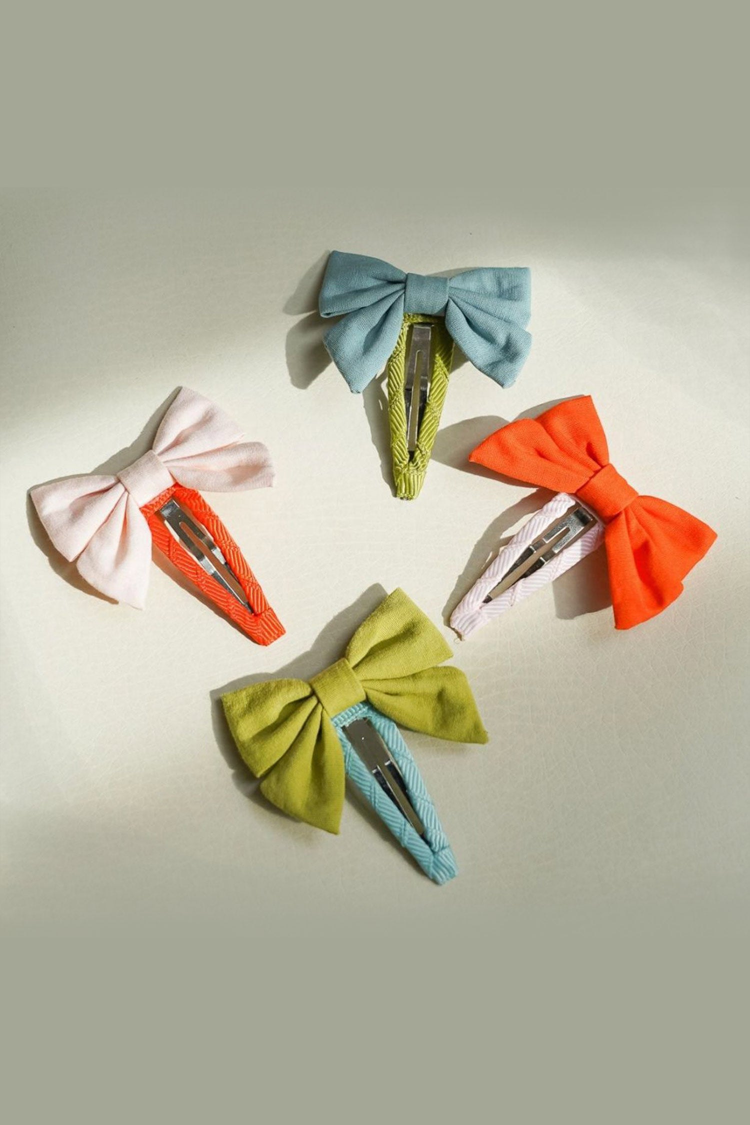 Beautiful bow hair clips in blue and green colour, snap clip is very gentle to the hair with a strong grip by Grech & Co. Shop online bow hairclips for girls.