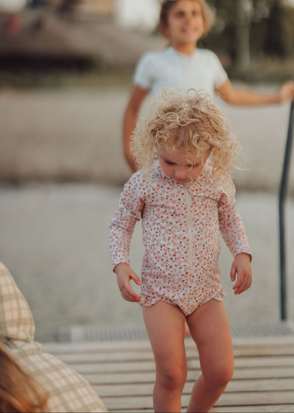 Full-length view of sustainable long sleeve swimsuit in Sunset Meadow print