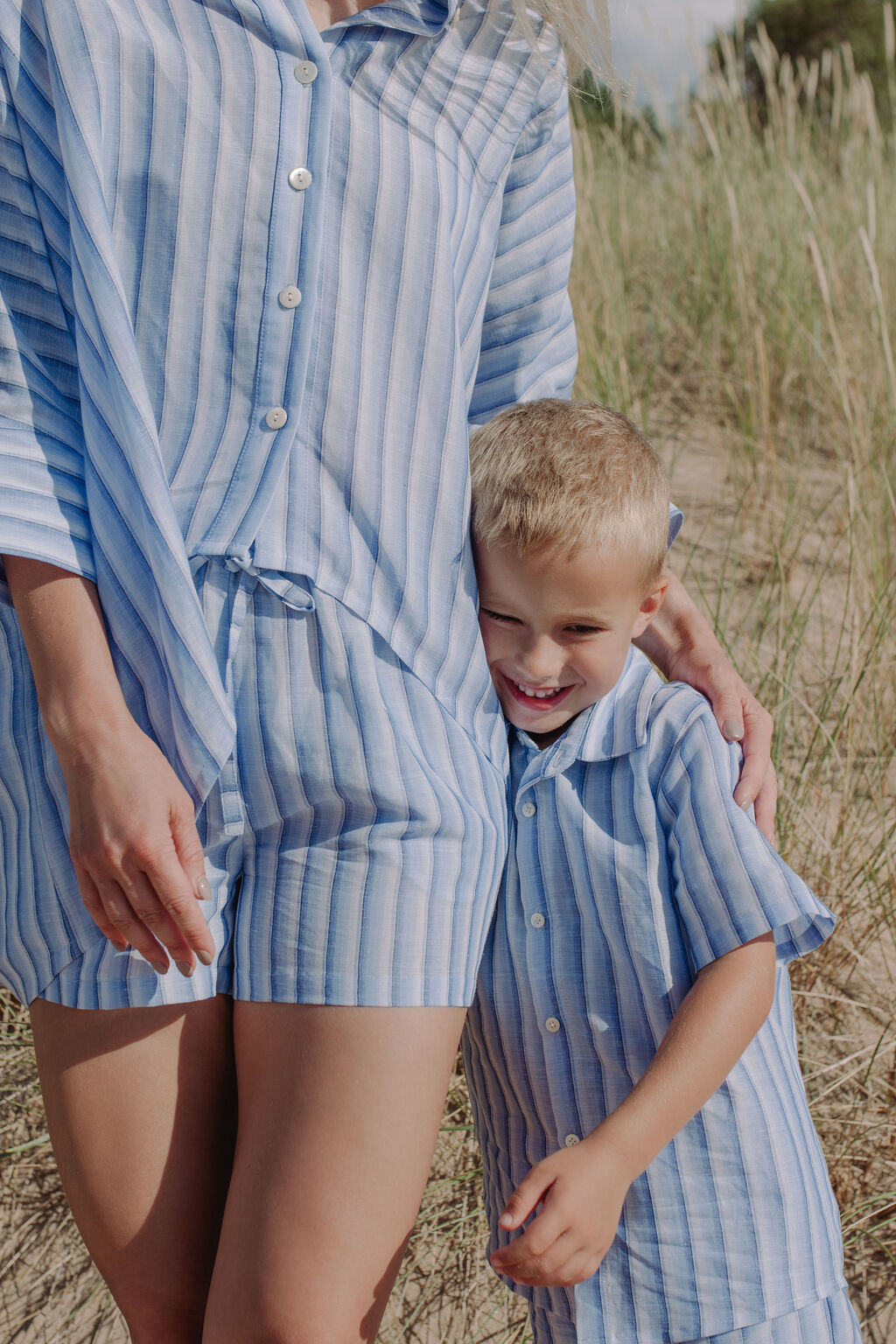 Blue and white striped linen shorts paired with matching top, beach vacation style.