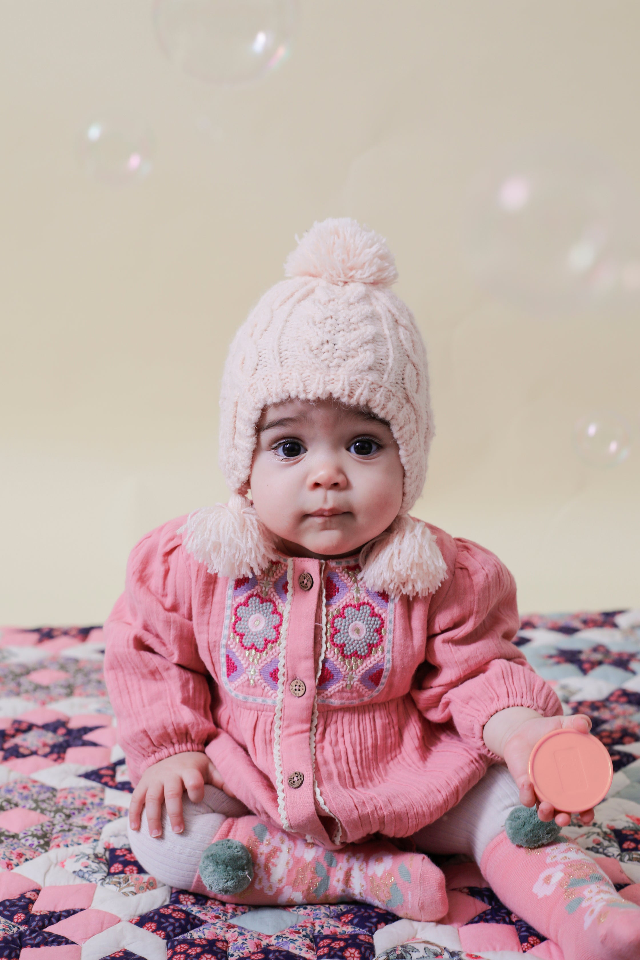 This pink romper for baby girls with embroideries is made with soft organic muslin, using organic cotton (GOTS) by Louise Misha. The best baby gift & presents.