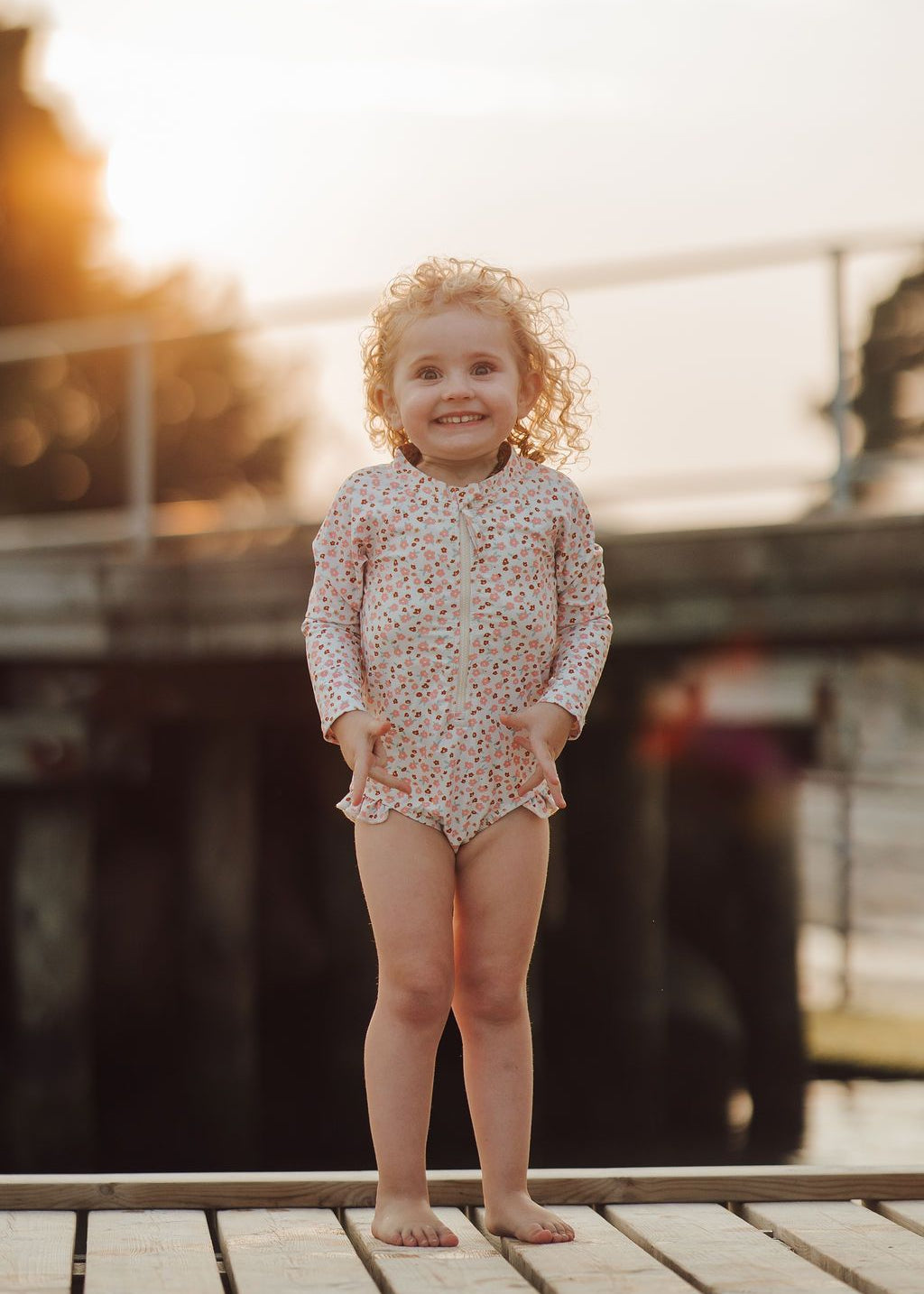 Back view of girls' long sleeve swimsuit in Sunset Meadow with full coverage design