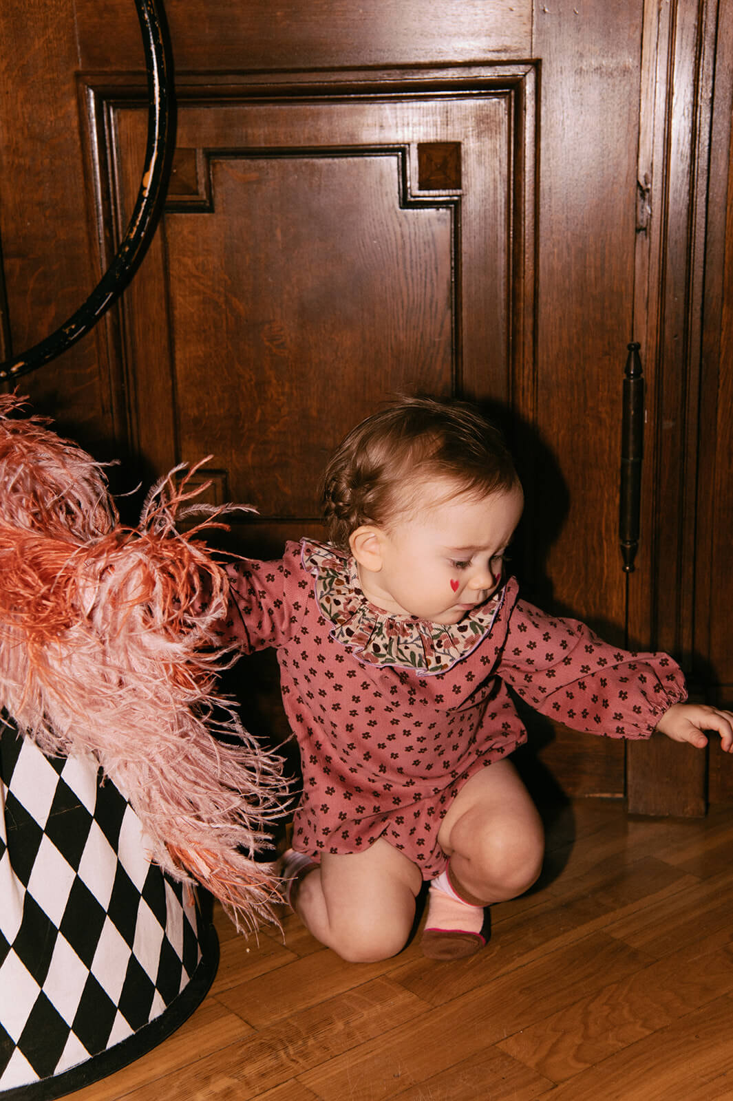 Pink velvet baby romper with a beautiful flower print - the best sustainable baby clothing. The baby girl romper with flowers is made of lightweight velvet.
