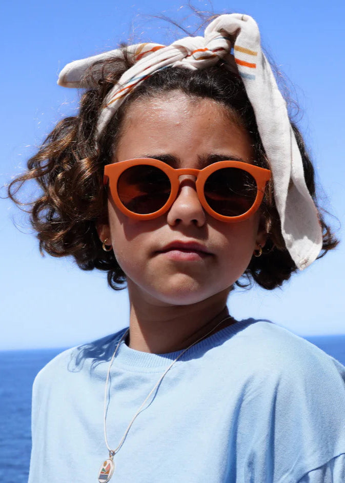 Sustainable sunglasses in orange by Grech & Co are eco-friendly/non-toxic break-resistant material with polarised lenses and UV400 protection. Best kids gift.