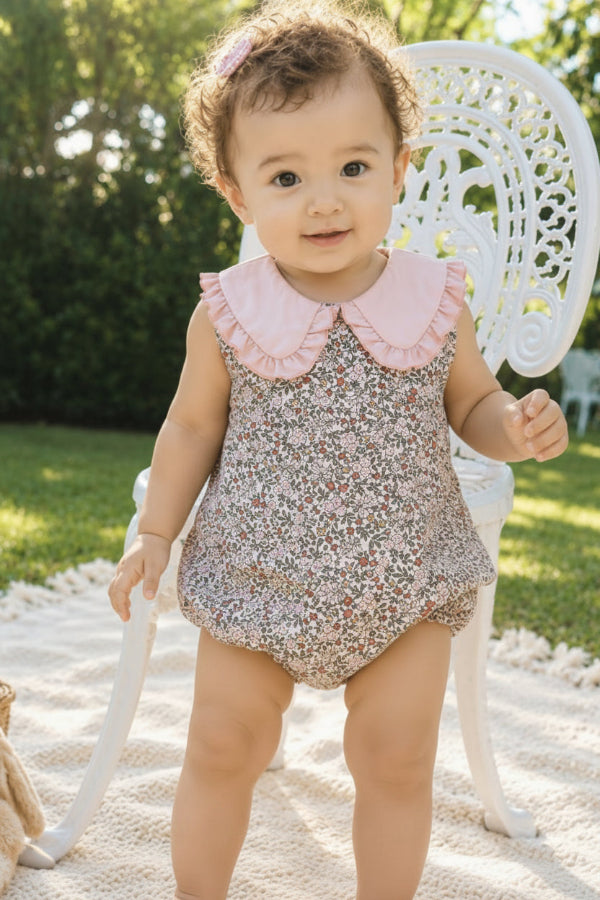 Close-up of all-over floral print and pink Peter Pan collar on organic cotton baby romper by Milimilu