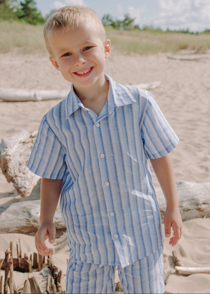 Boy wearing breathable blue striped linen shirt - lightweight summer clothing for kids