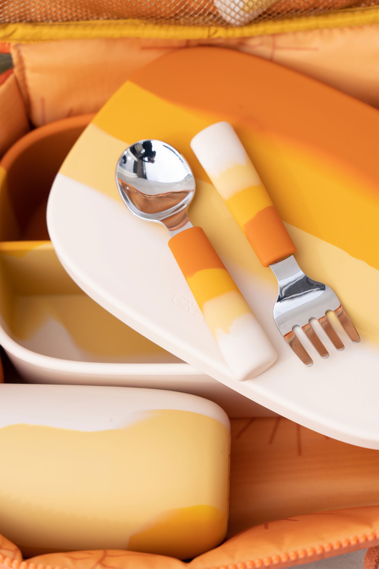 Cutlery sets for toddlers and kids for bbay lead weaning in orange colour online. Shop eco friendly silicon spoon for toddlers meal time for mess free meals.