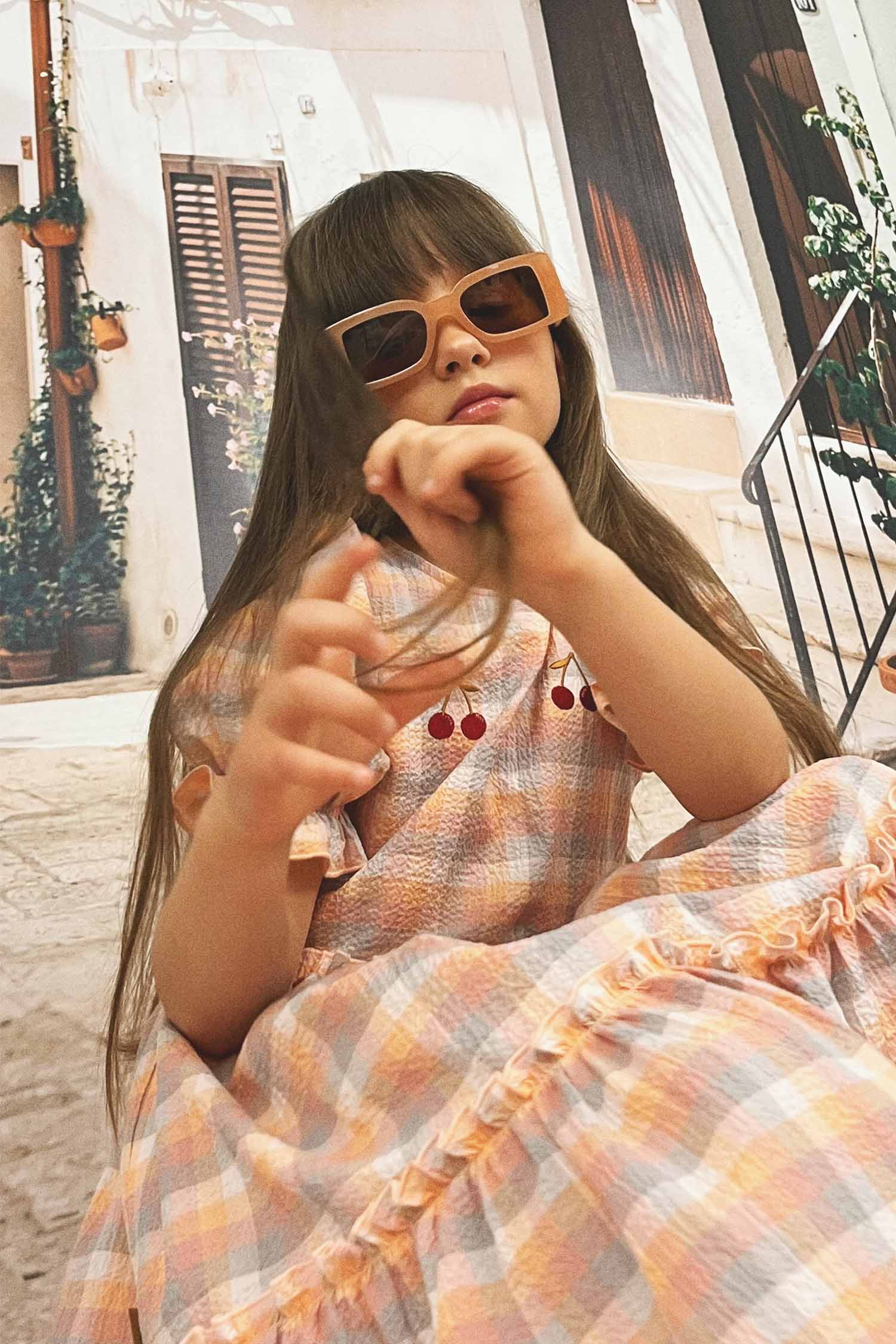 Cherry print summer dress for girls, detail shot highlighting puff sleeves and quality fabric, organic cotton fabric.