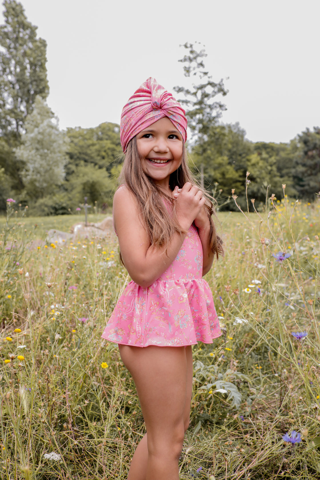 girls pink swimsuit in romance print is must have by Louise Misha. Made from SPF 50 sun-protective recycled fabric. Mini Me swimwear is available.