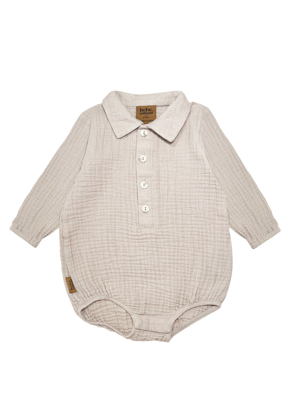 Baby wearing a light grey organic muslin romper, comfortable fit and breathable fabric.