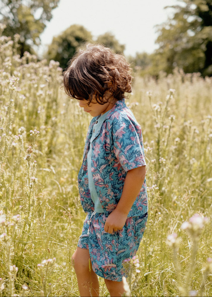 Boy wearing Louise Misha Alov teal floral shirt — lightweight organic cotton summer shirt for kids