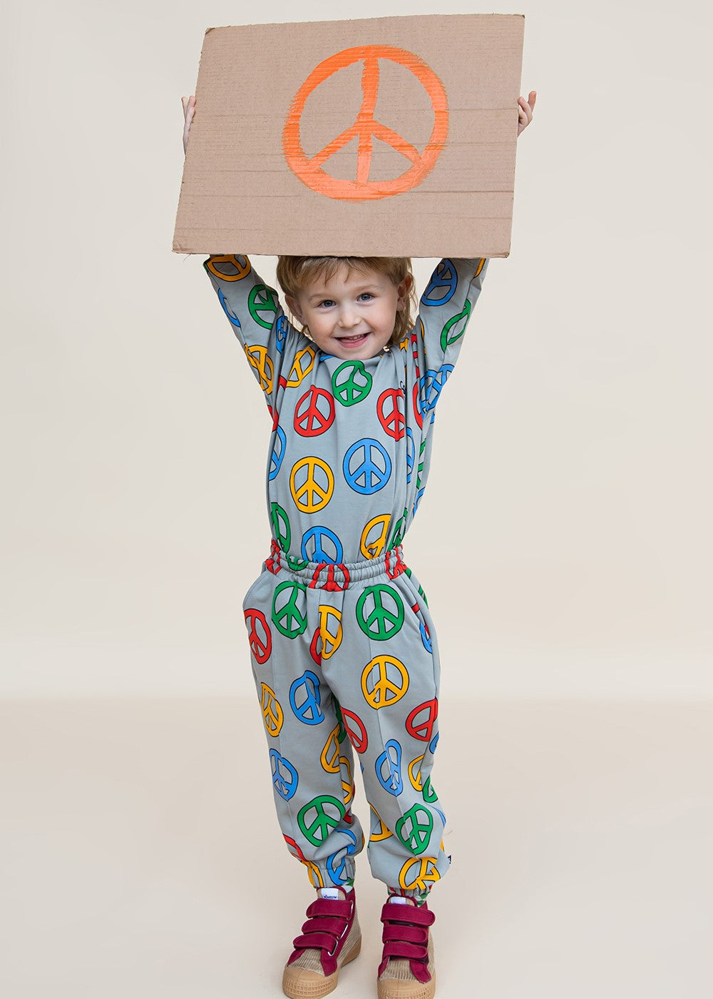 Child wearing CarlijnQ organic cotton Peace joggers — full body lifestyle view