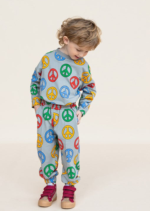 Close-up of Peace print on CarlijnQ organic cotton kids joggers — GOTS certified fabric detail