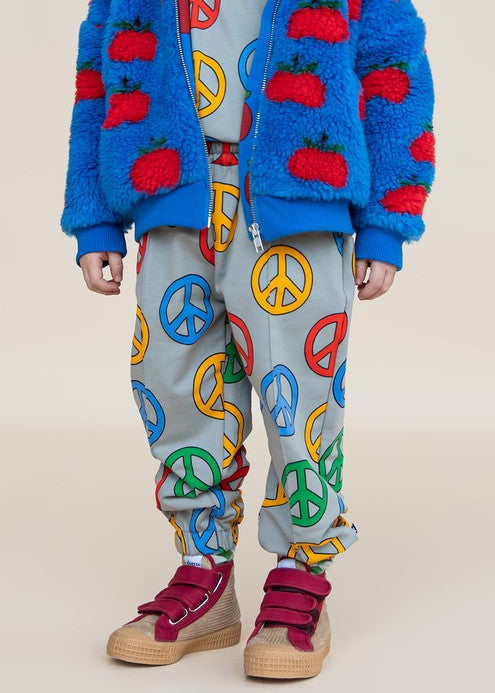 Side view of CarlijnQ Kids Peace joggers showing Peace symbol print — relaxed fit organic cotton