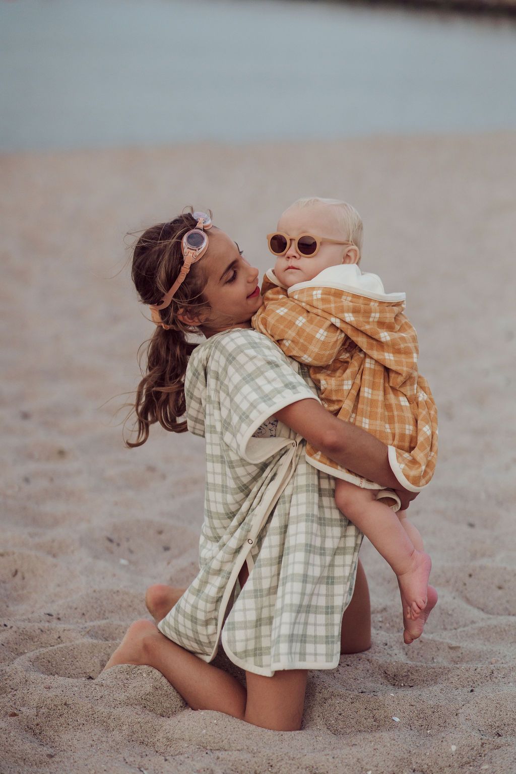 Grech & Co organic cotton towel poncho in fern green is the perfect blend of comfort. The retro-inspired hooded beach poncho for kids, shop kids beach clothing.