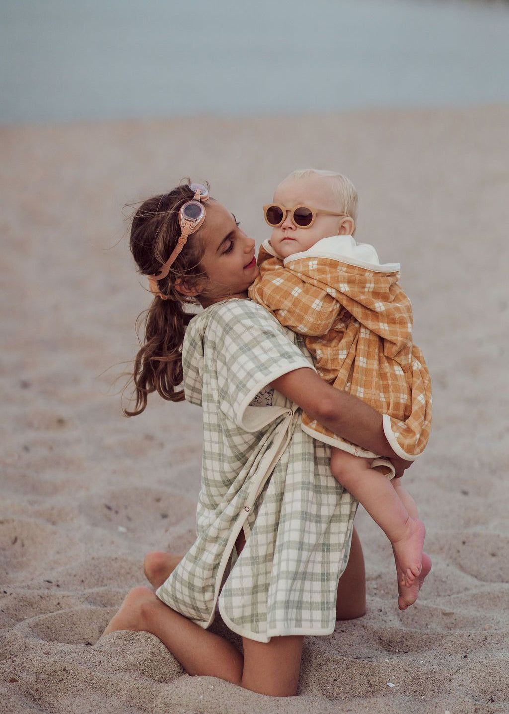 Back view of kids beach poncho in fern plaid with hood and organic cotton fabric