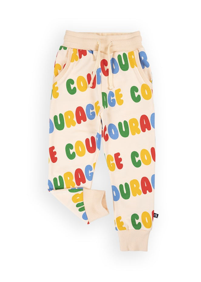 Close-up of CarlijnQ Courage print on organic cotton kids sweatpants — GOTS certified fabric detail