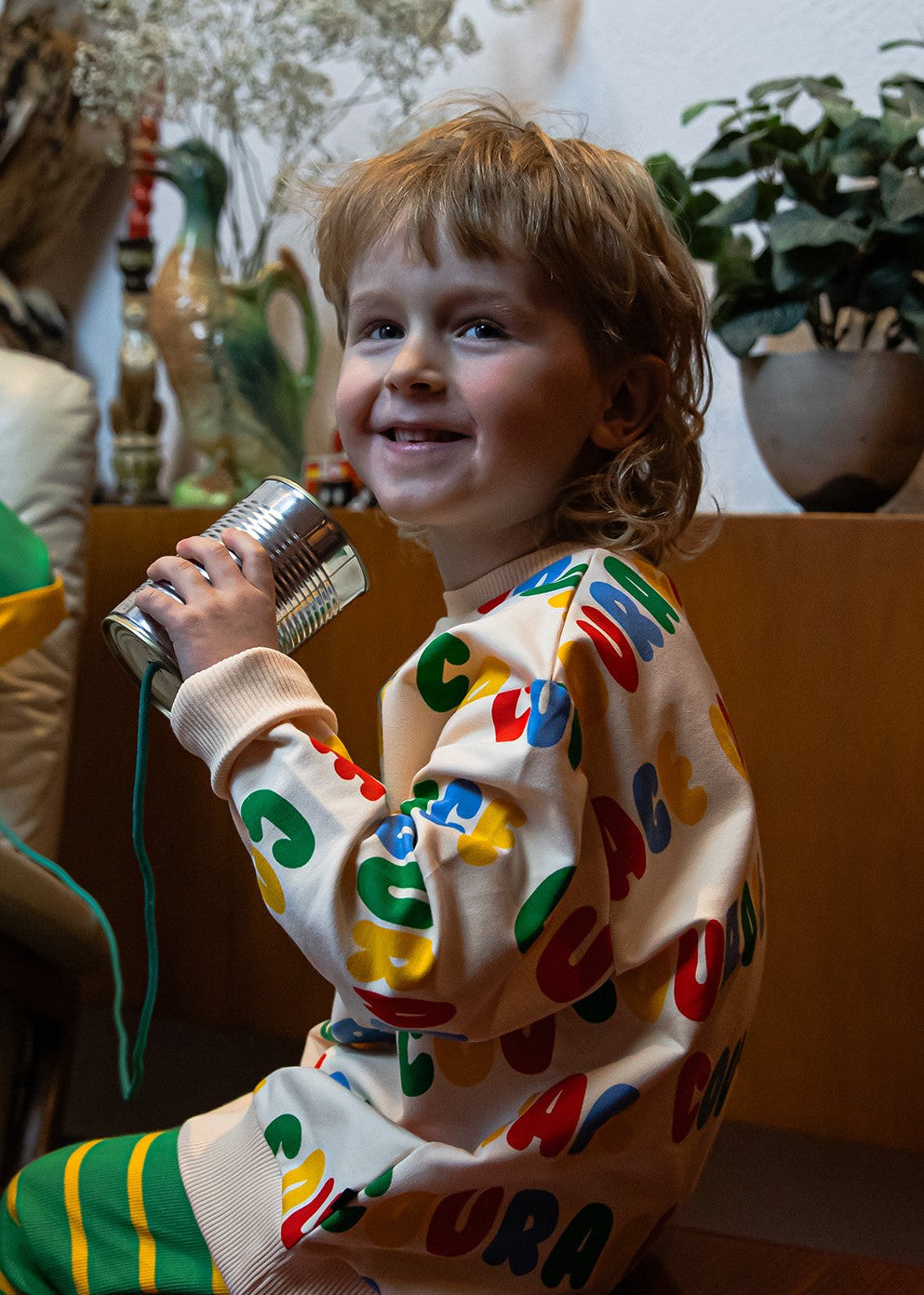 Kids organic cotton sweater with colourful Courage print; lifestyle view.