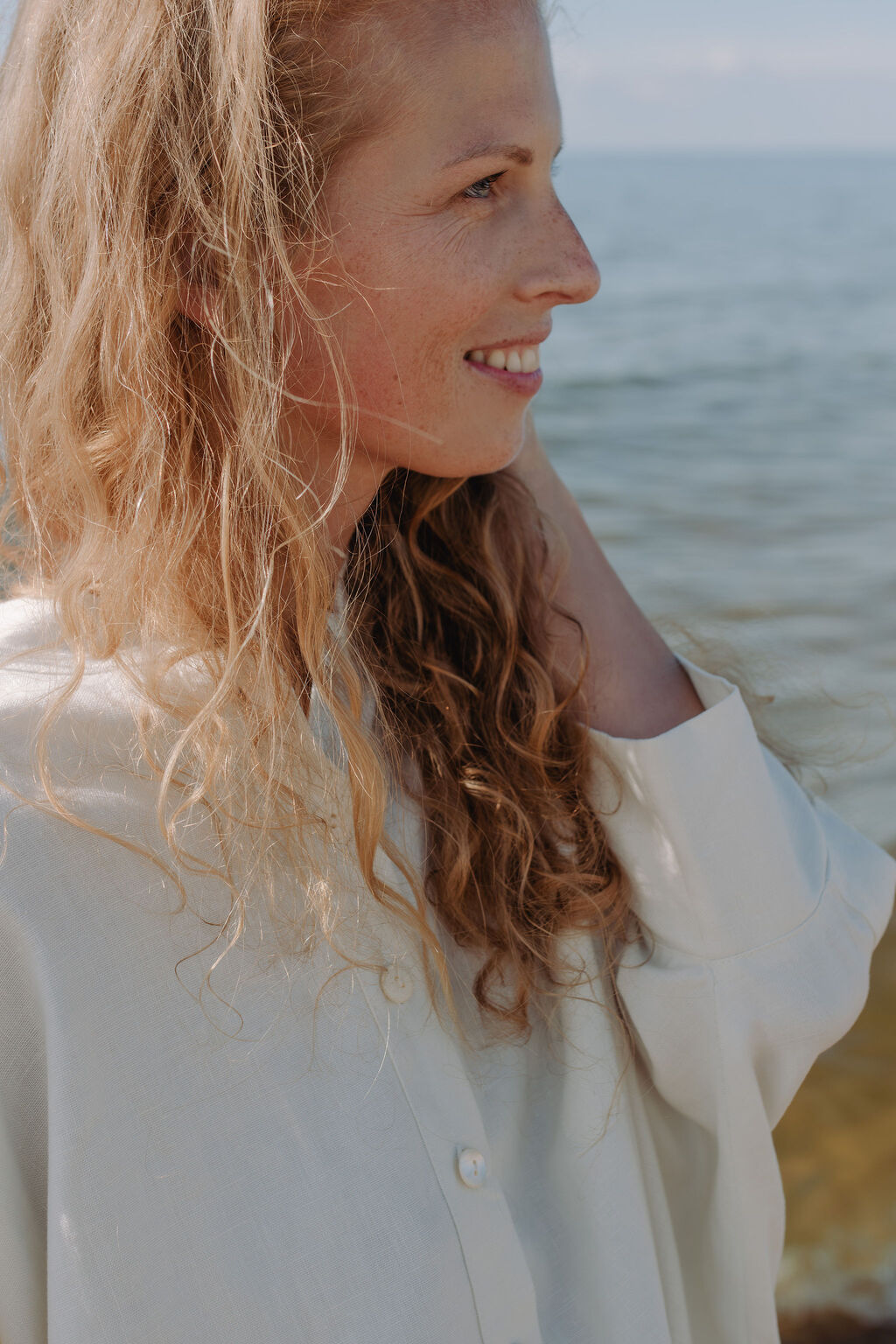 Women's oversized white linen shirt detail showing premium fabric texture and relaxed silhouette - sustainable fashion by MiliMilu.