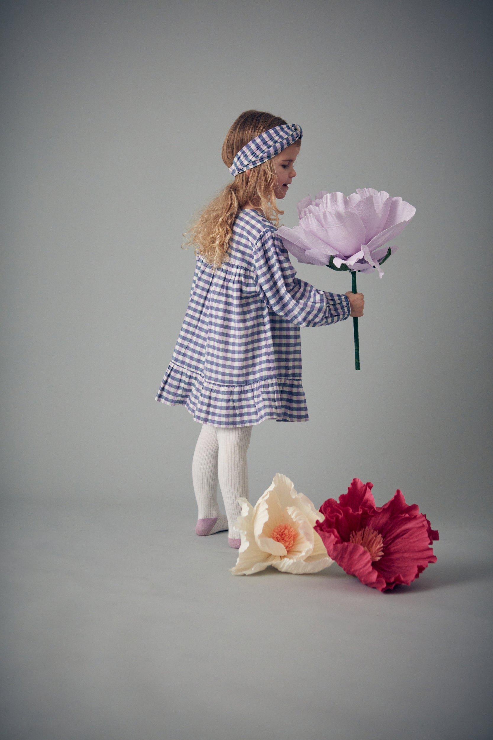 Massilian organic cotton dress is a stunning piece in a soft purple and blue check pattern. Shop the best sustainable kids clothing by Louise Misha at MiliMilu.