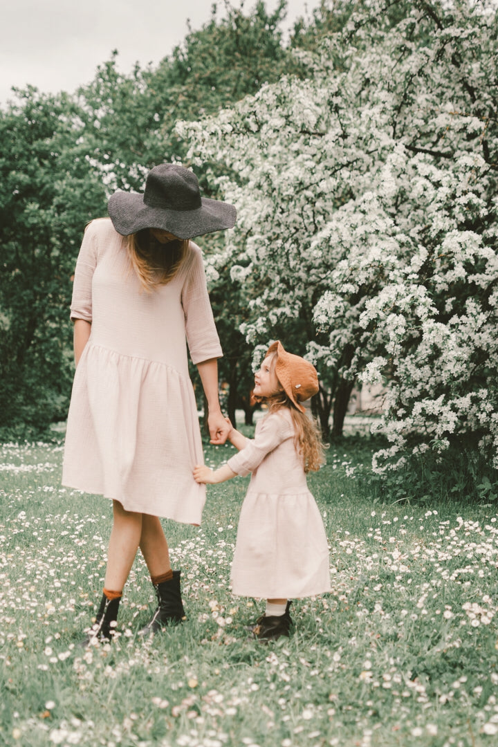 Latvian artisans beautifully handcraft our Back to Nature dress in soft pink colour from organic cotton. Mini-me styles are available for matching on Mommy and daughters' days out! The Back to Nature dress is perfect to be worn while exploring and connecting with nature and making you look gorgeous during a family day out. The collection is made from breathable and organic cotton for cooler weather to protect your skin from the sun.